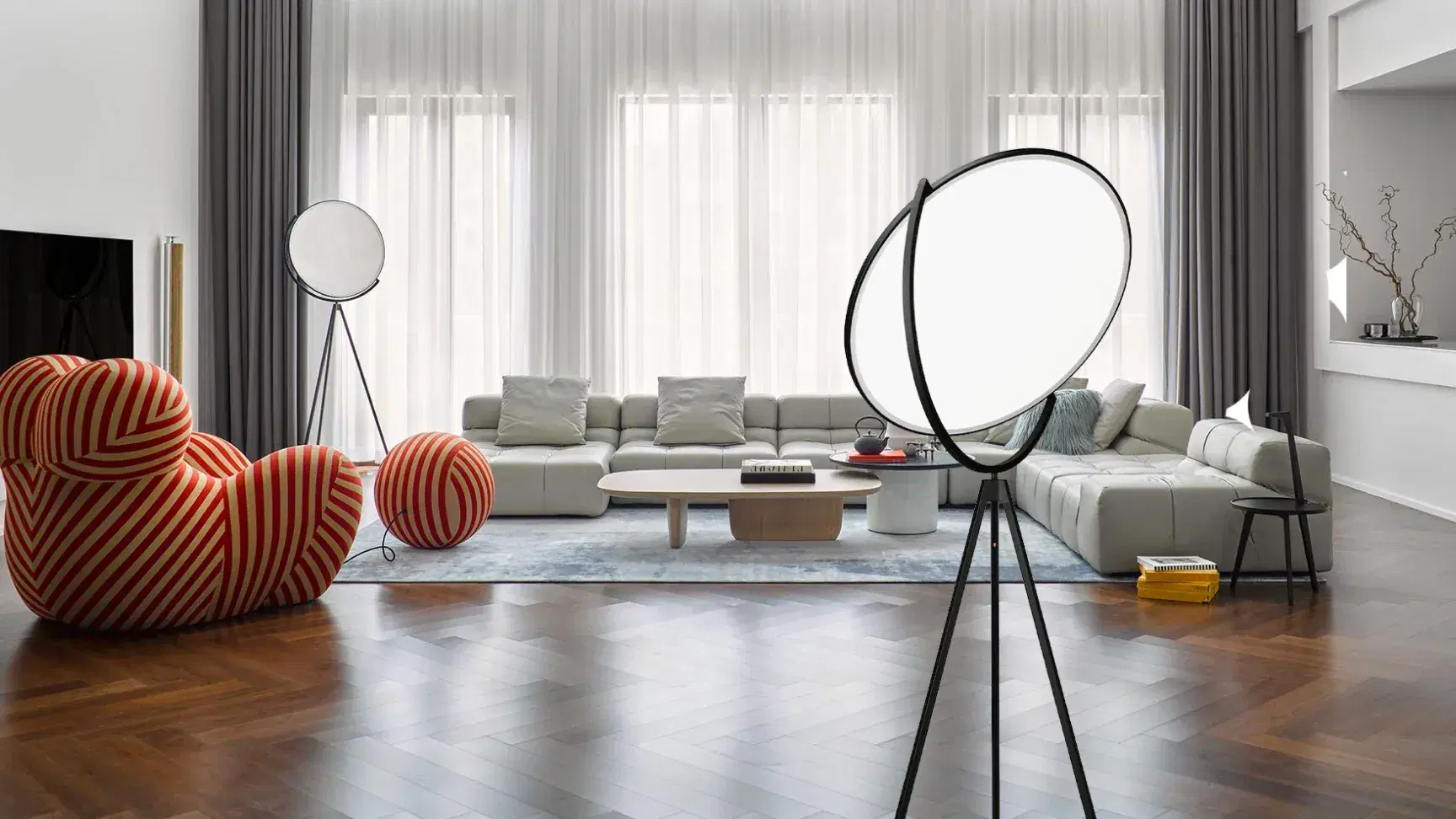 A living room featuring La Mama Armchair and Superloon Floor Lamp