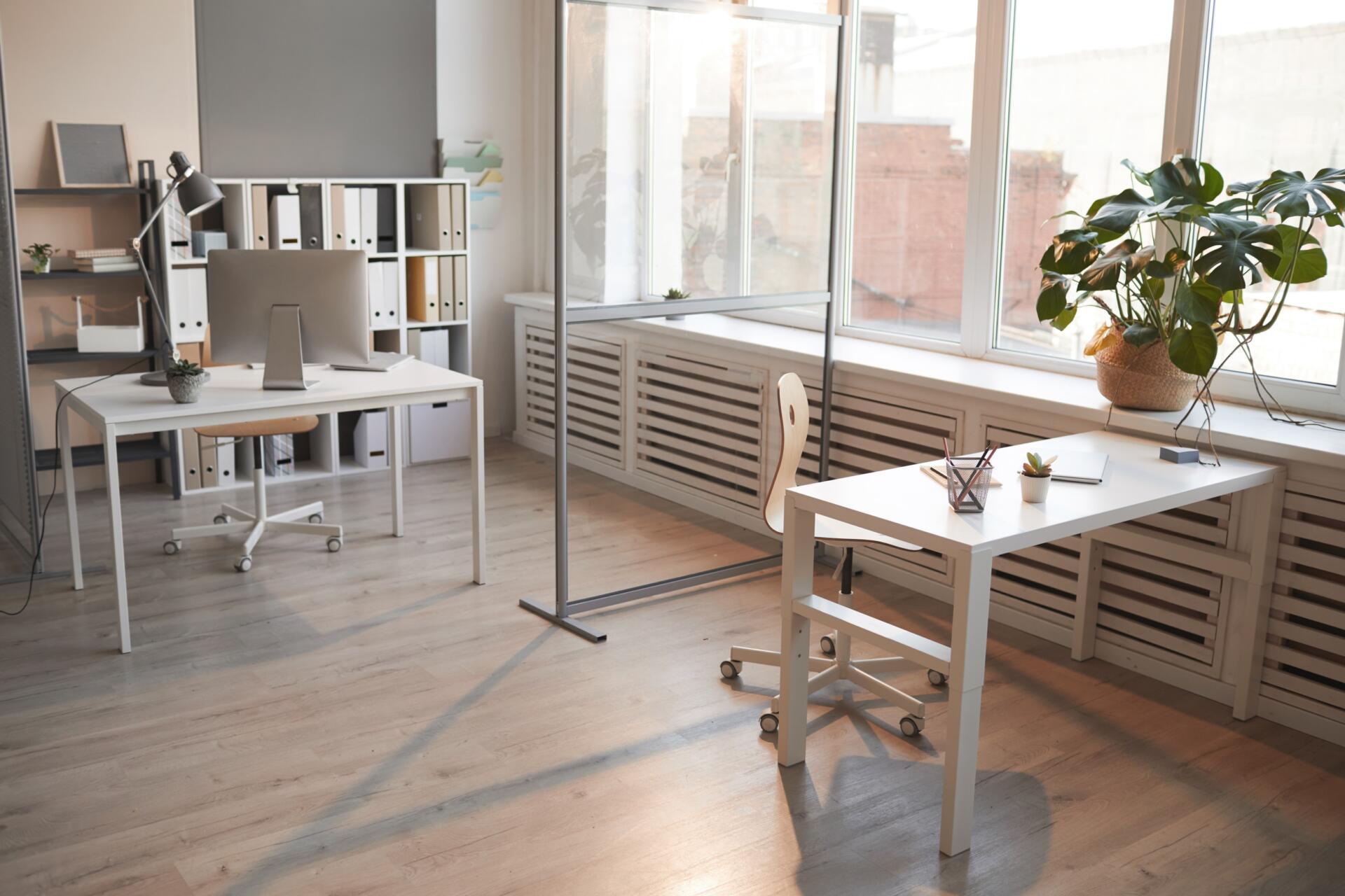 well-planned small office arrangement with double table setup, one in the corner and the other in front of window